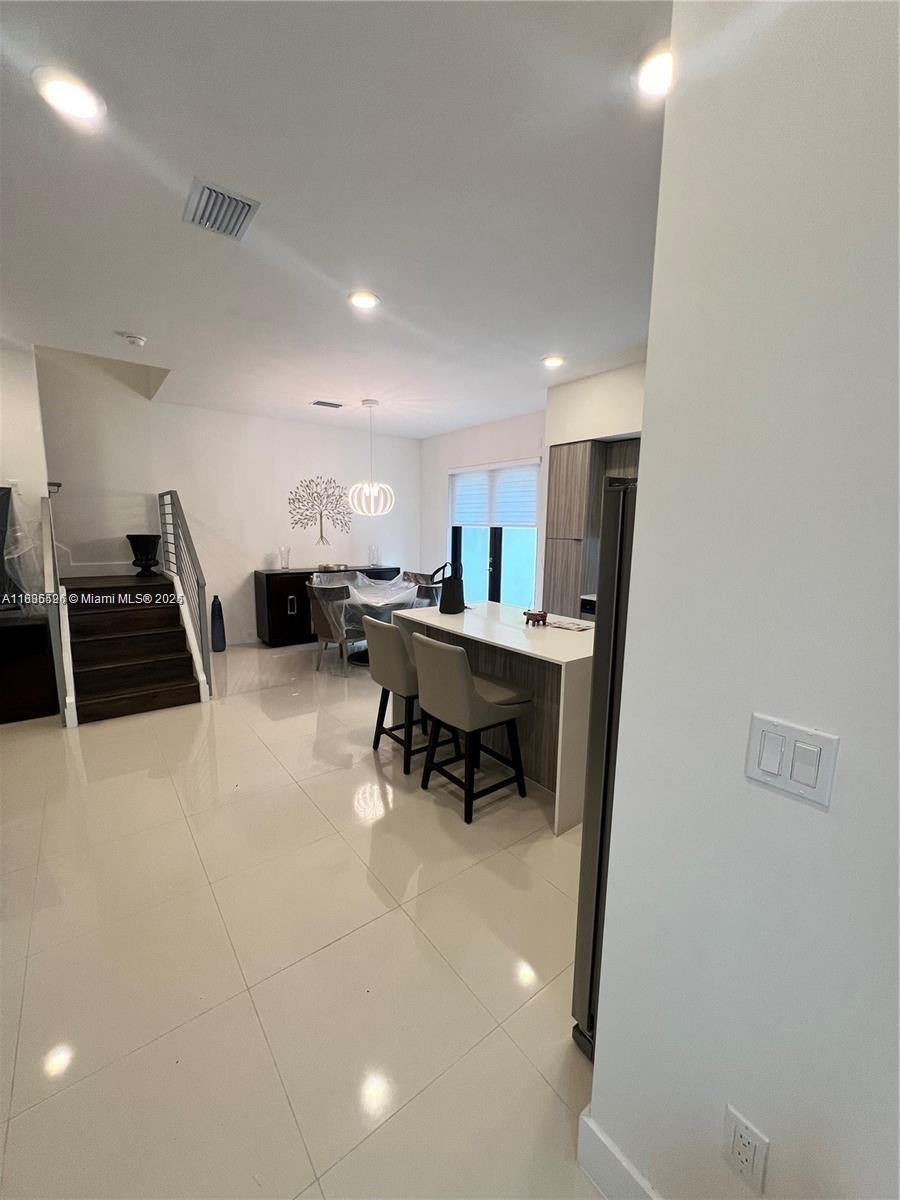 Kendall Miami, FL 33186 - Photo 3 of 30 a kitchen with a sink a stove a refrigerator and chairs