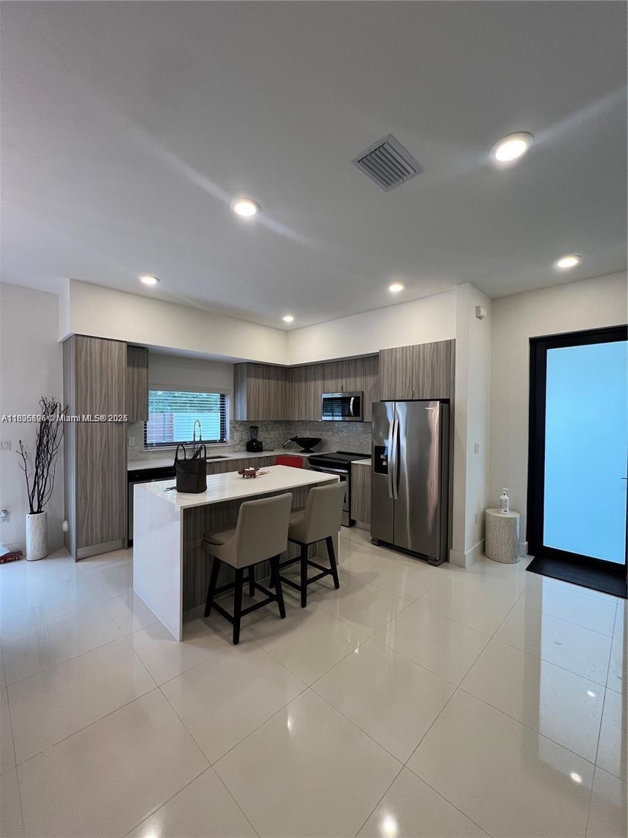 Kendall Miami, FL 33186 - Photo 4 of 30 a kitchen with stainless steel appliances a refrigerator and a dining table
