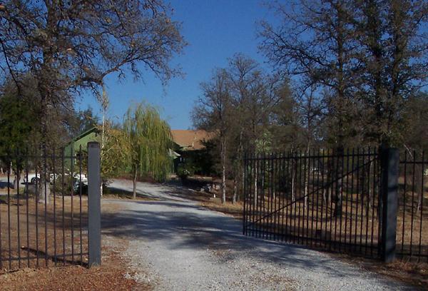 a view of backyard with wooden fence