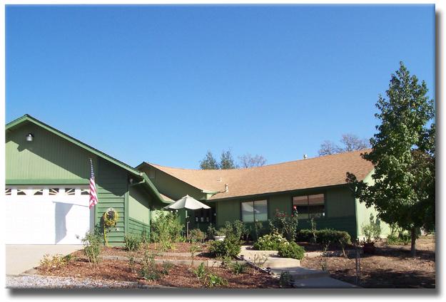 12583 Intermountain Road Redding, CA 96003 - Photo 2 of 5 a front view of a house with garden