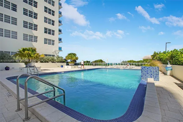 a view of a swimming pool with an outdoor seating