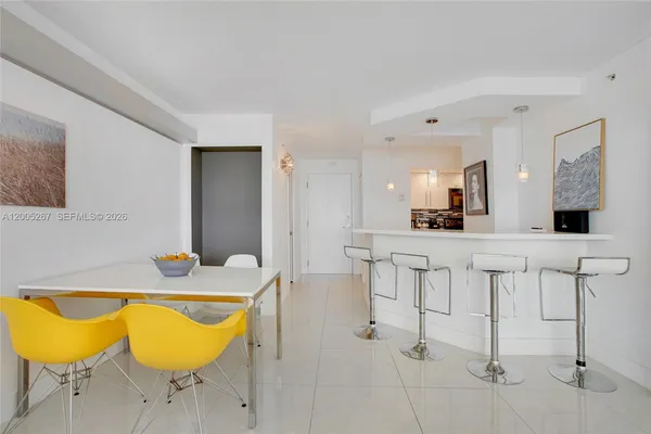 a view of a dining room with furniture and a kitchen
