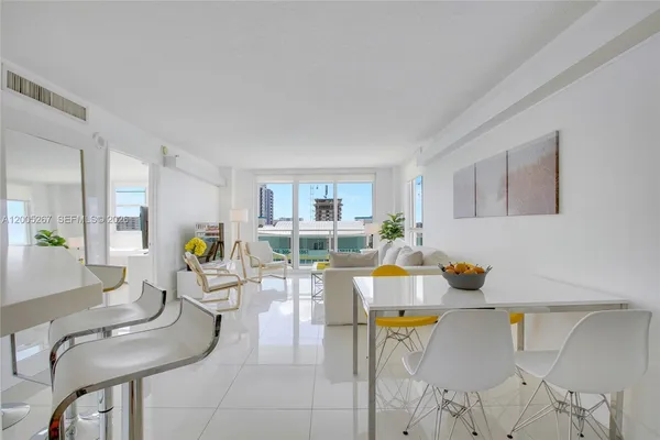 a living room with furniture and floor to ceiling windows
