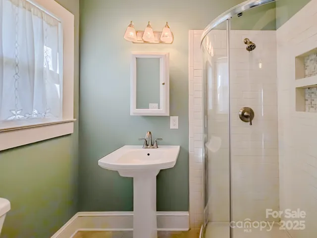 a bathroom with a sink mirror and tub