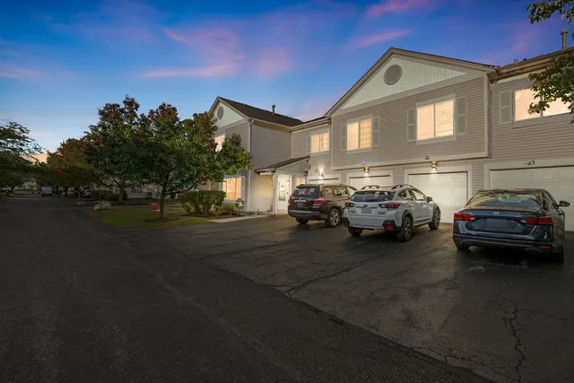 a couple of cars parked in front of a house