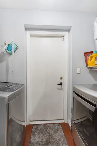 a view of an entryway with wooden floor
