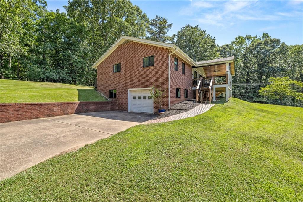 6470 Samoa Way Flowery Branch, GA 30542 - Photo 60 of 61 a view of a house with a yard