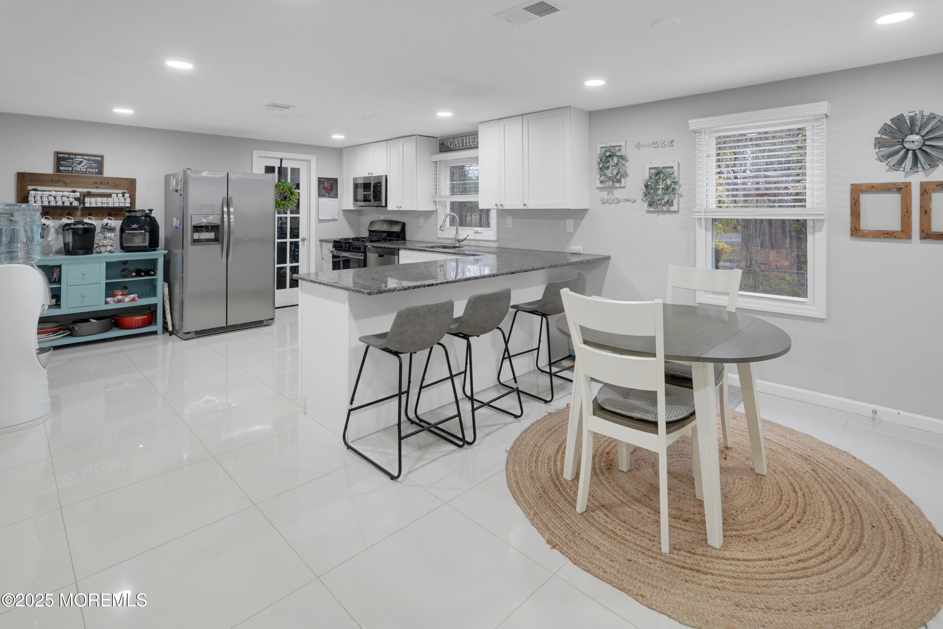 336 Jackson Mills Road Jackson, NJ 08527 - Photo 15 of 45 a kitchen with stainless steel appliances granite countertop a table chairs and a refrigerator
