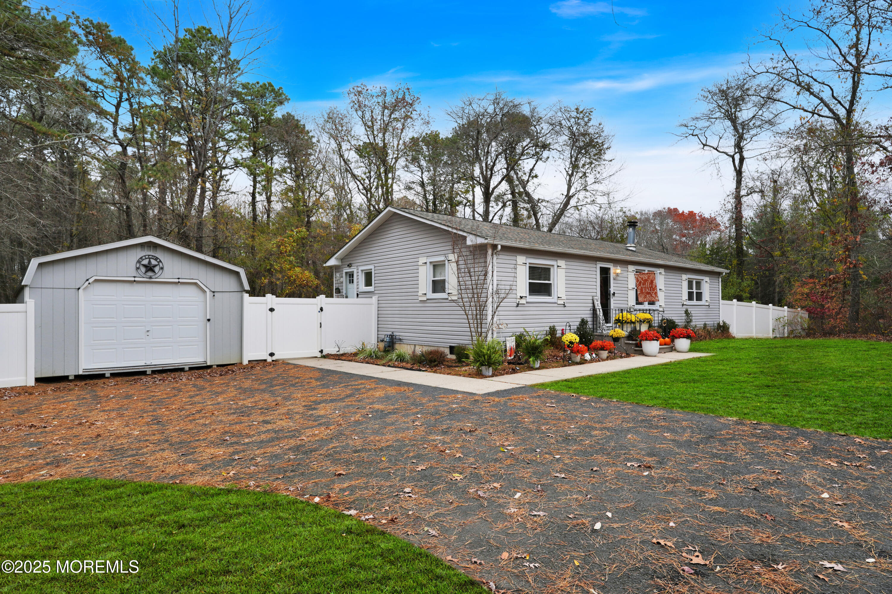 336 Jackson Mills Road Jackson, NJ 08527 - Photo 35 of 45 a view of a white house with a small yard and large trees