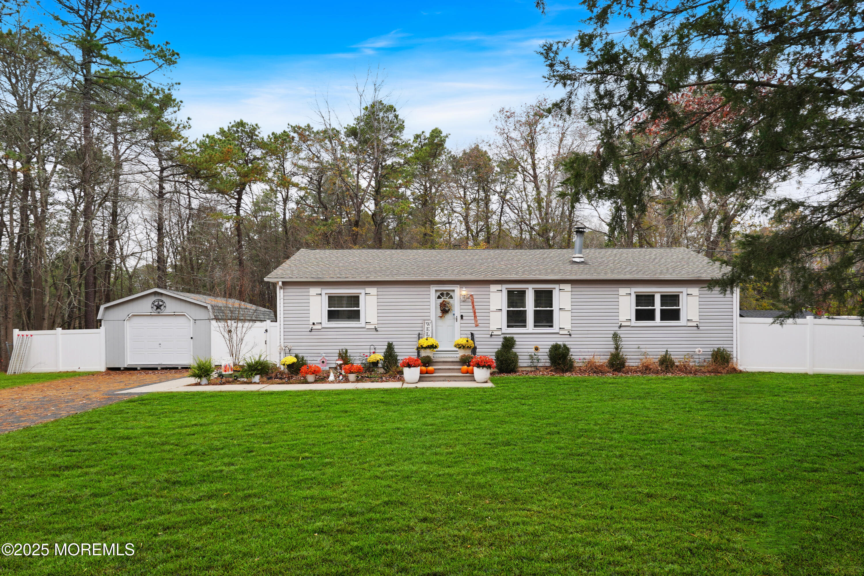 336 Jackson Mills Road Jackson, NJ 08527 - Photo 36 of 45 a front view of a house with a yard and trees