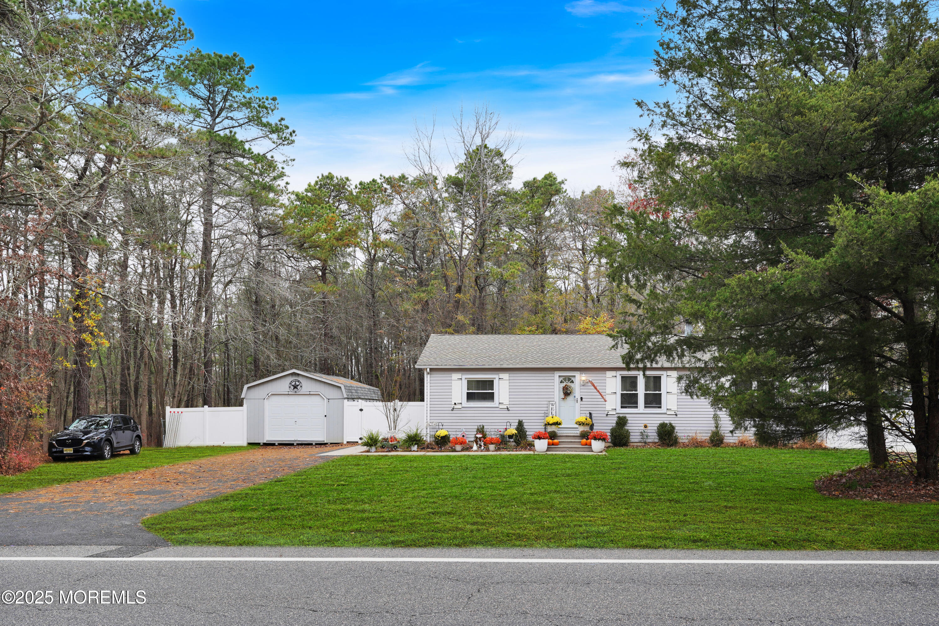 336 Jackson Mills Road Jackson, NJ 08527 - Photo 41 of 45 a view of a white house with a big yard and large trees