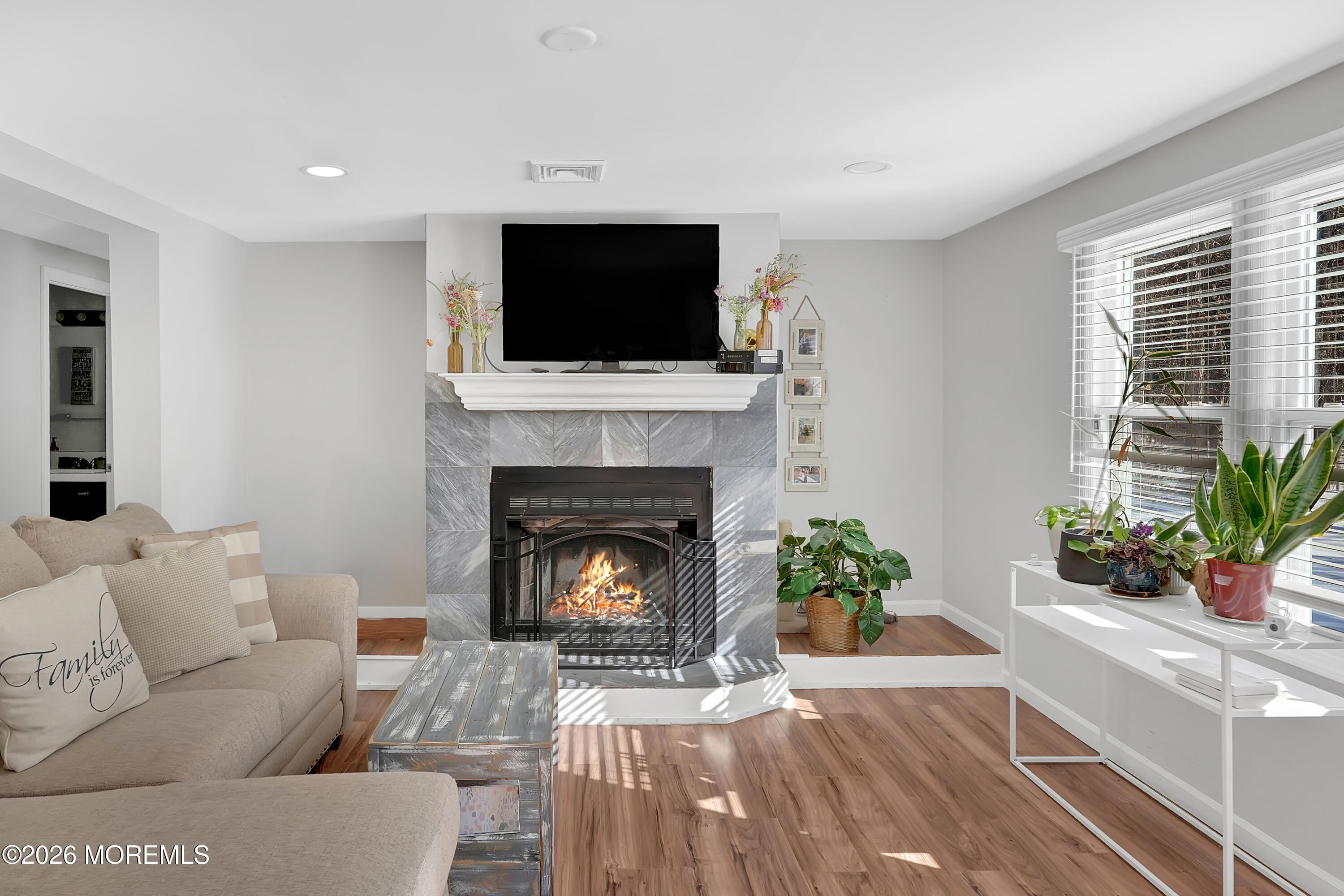 336 Jackson Mills Road Jackson, NJ 08527 - Photo 7 of 45 a living room with furniture a flat screen tv and a fireplace