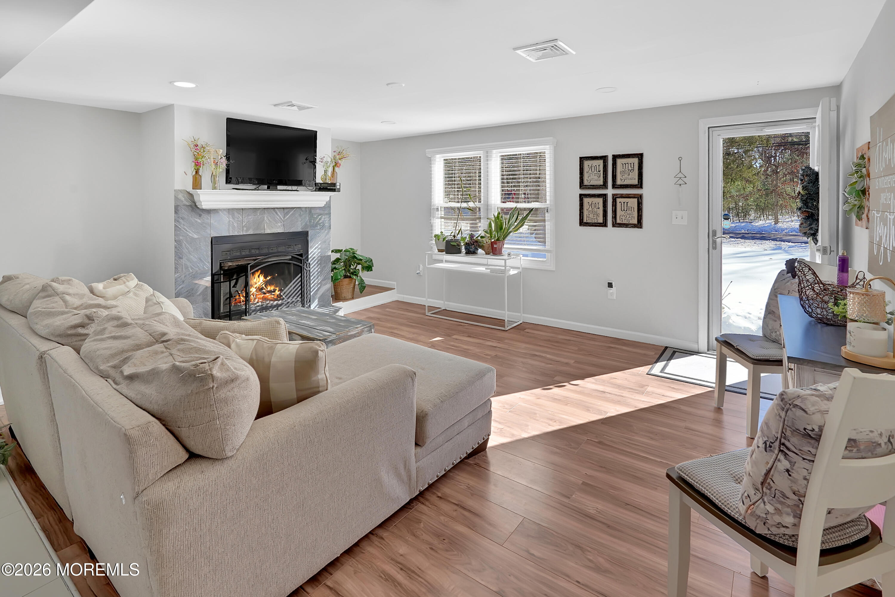 336 Jackson Mills Road Jackson, NJ 08527 - Photo 8 of 45 a living room with furniture a flat screen tv and a fireplace