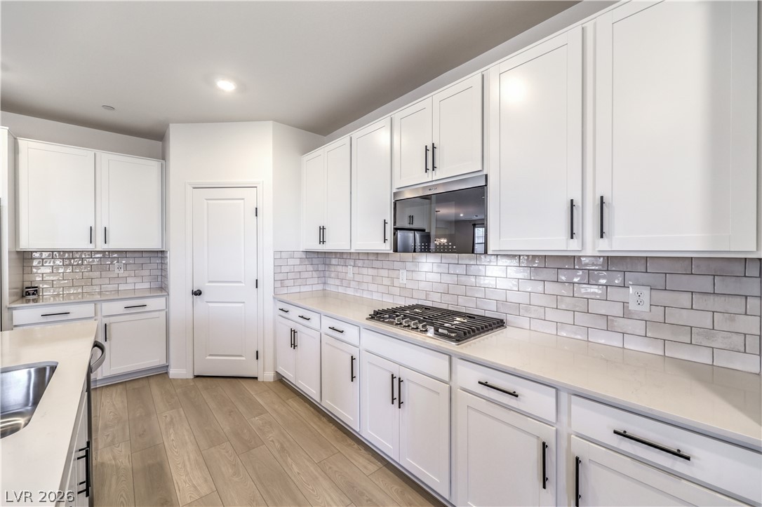 3782 Alla Rocca Avenue Henderson, NV 89044 - Photo 13 of 55 Bright and airy kitchen featuring pristine cabinetry, sleek countertops, and modern appliances.