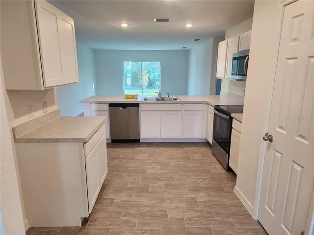a kitchen with a sink stove and refrigerator