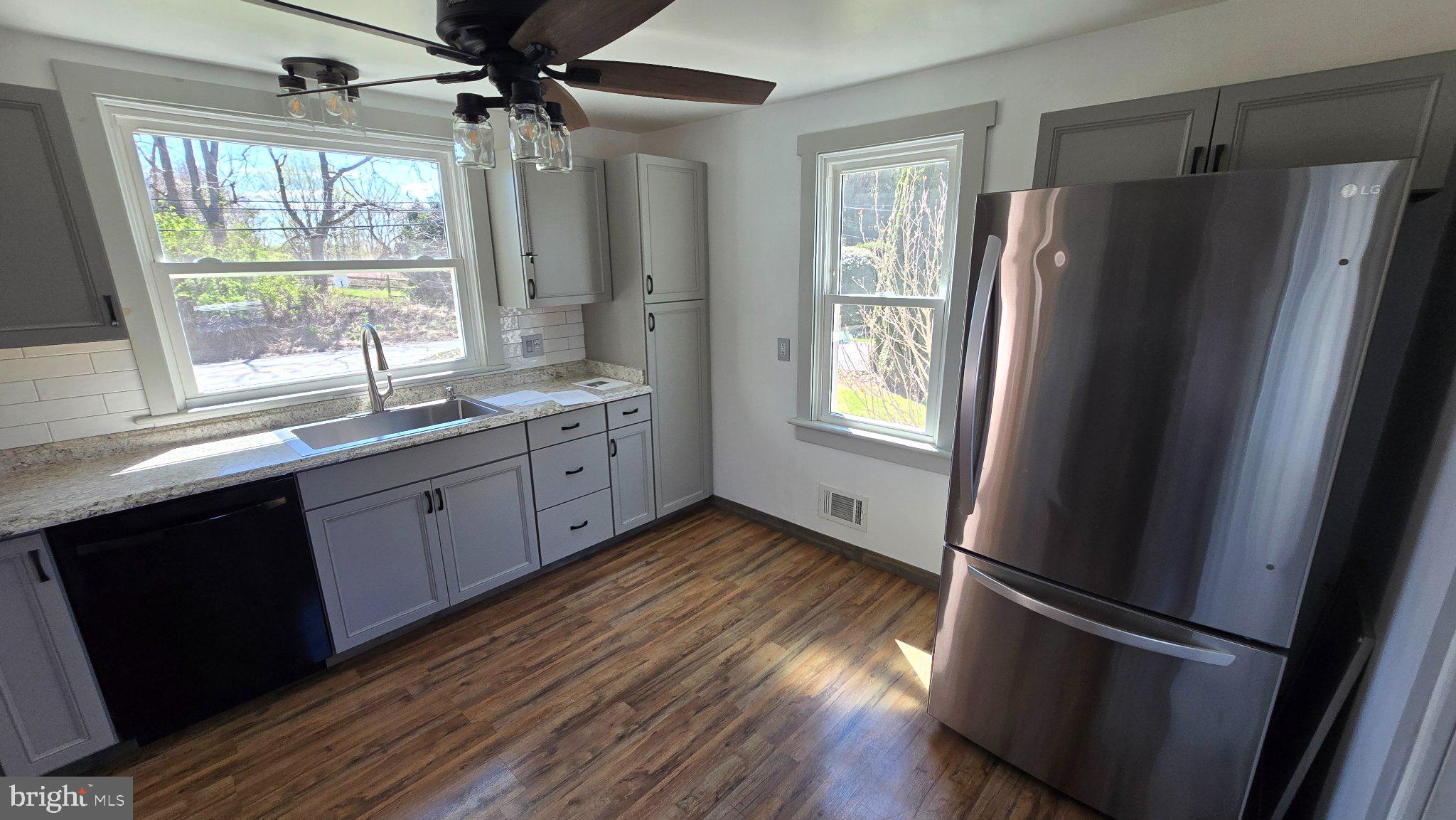 1233 New London Road Landenberg, PA 19350 - Photo 11 of 37 a kitchen with stainless steel appliances a refrigerator sink and window