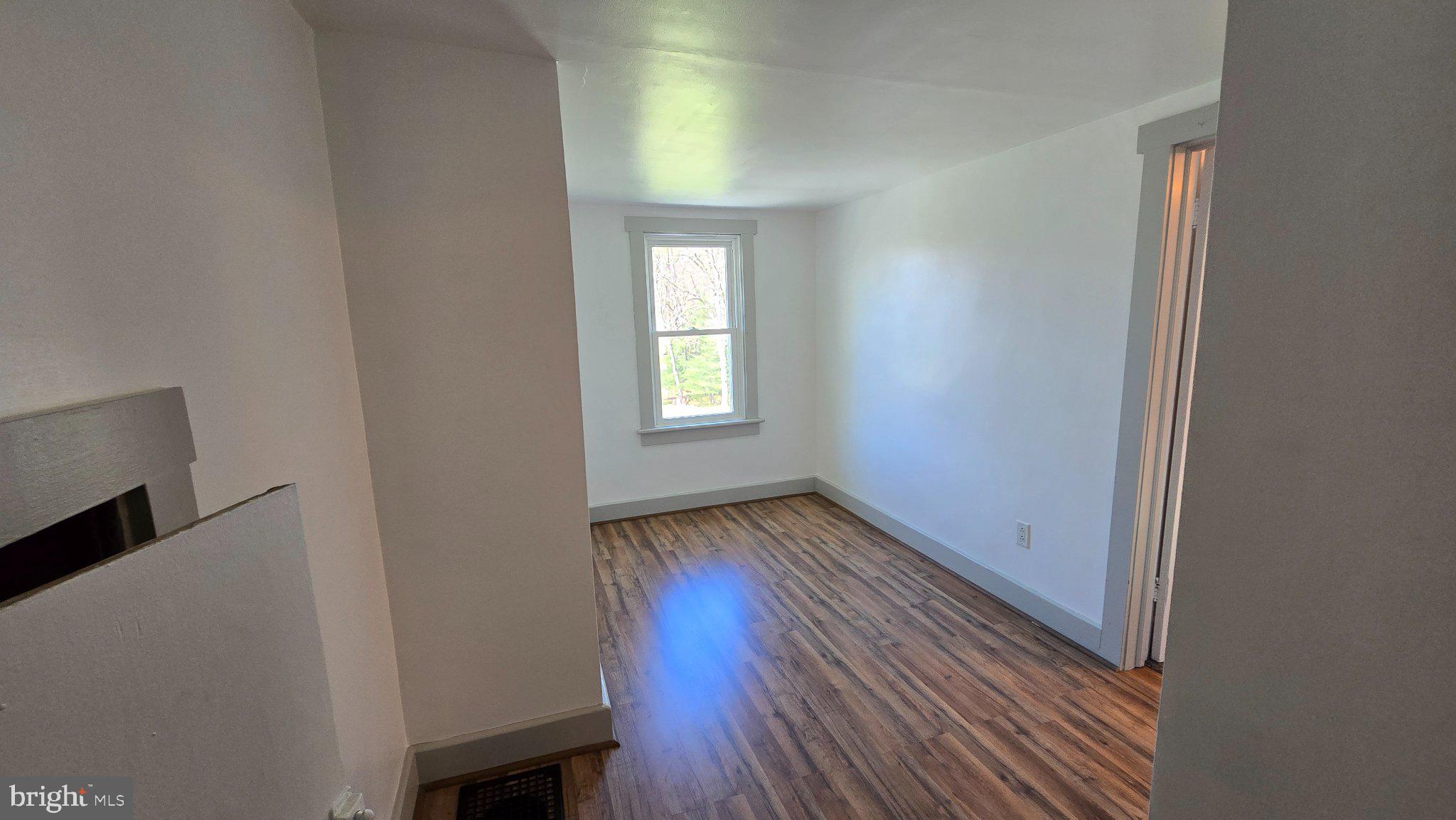 1233 New London Road Landenberg, PA 19350 - Photo 19 of 37 a view of an empty room with wooden floor and a window