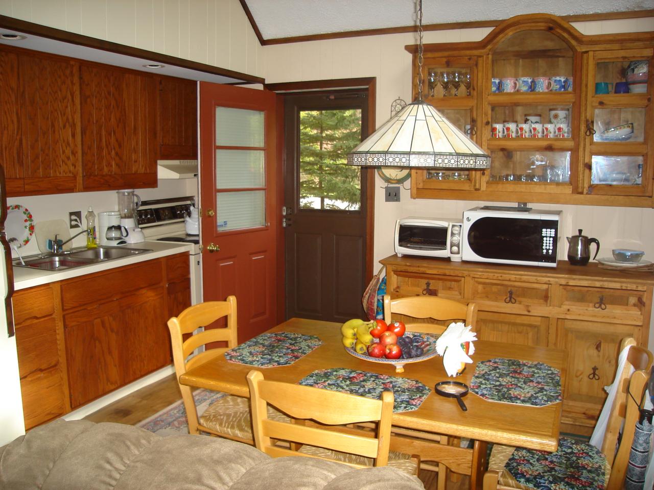 967 Decker Road Bushkill, PA 18324 - Photo 2 of 12 a kitchen with a stove a refrigerator and a dining table