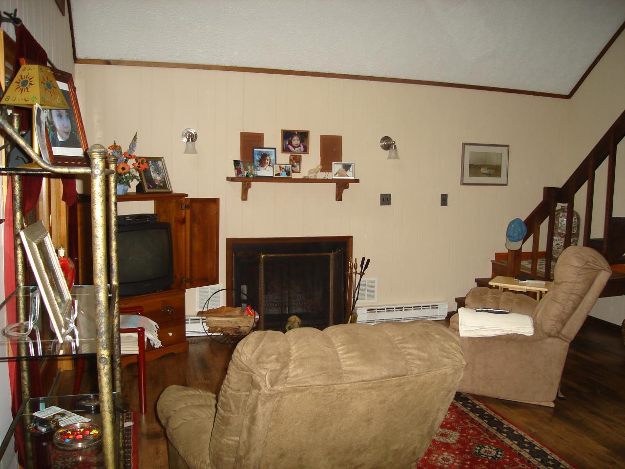 967 Decker Road Bushkill, PA 18324 - Photo 4 of 12 a living room with furniture a flat screen tv and a fireplace