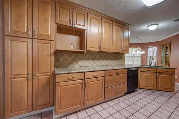 a kitchen with stainless steel appliances granite countertop a refrigerator and cabinets