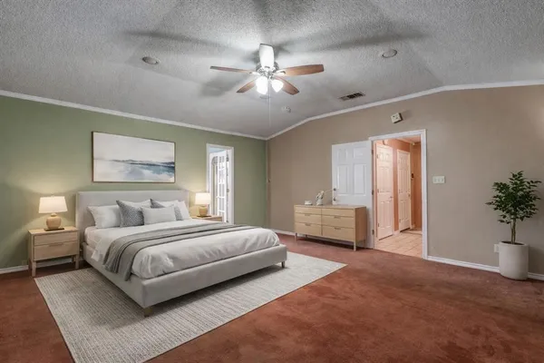 a bedroom with a large bed and a chandelier