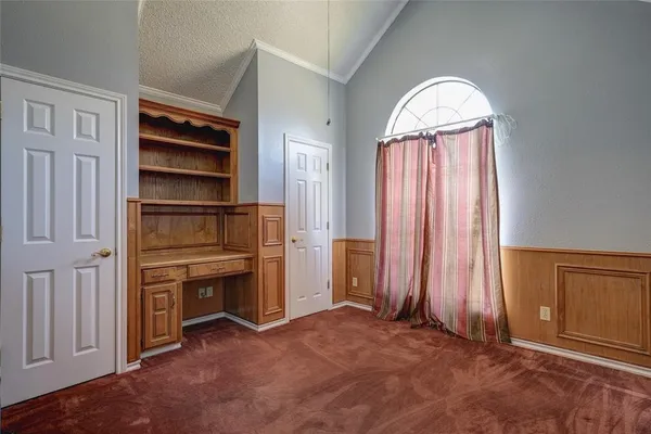 a view of an empty room with a fireplace and a window