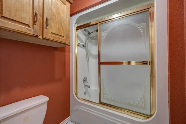 an empty room with closet and fan