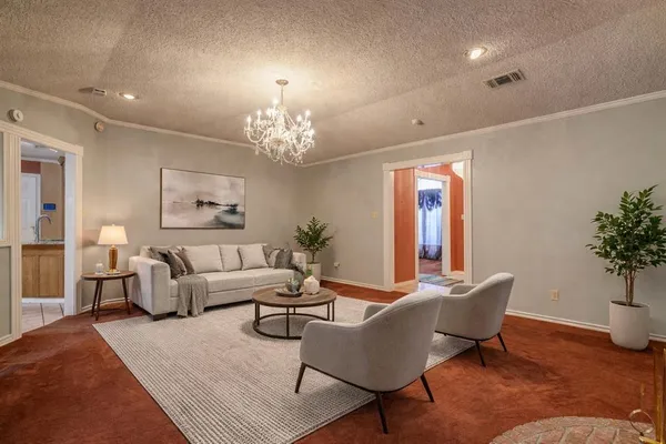 a living room with furniture and a chandelier