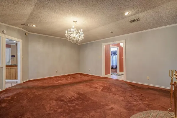 a view of an empty room with a chandelier