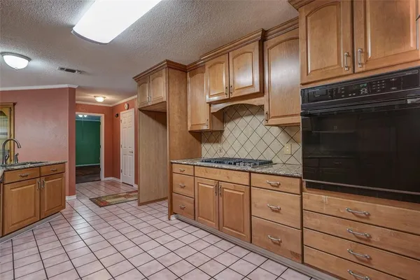 a kitchen with granite countertop cabinets stainless steel appliances and a sink