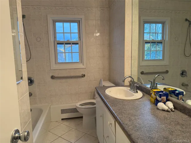 a bathroom with a sink double vanity and a toilet