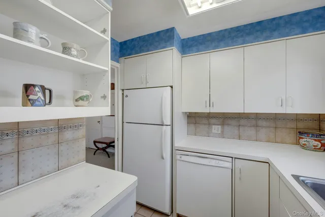 a spacious bedroom with a bed and a flat screen tv