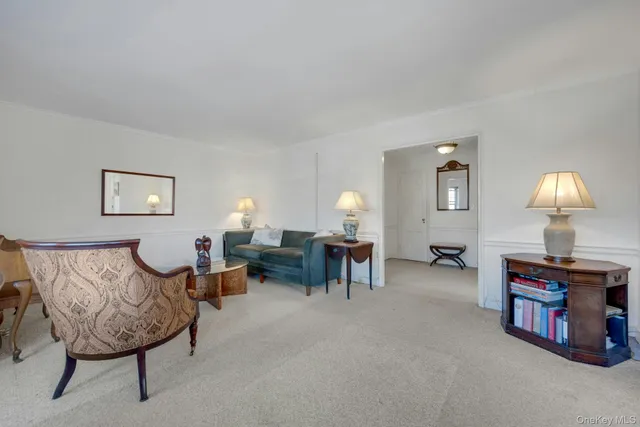 a living room with furniture and a lamp