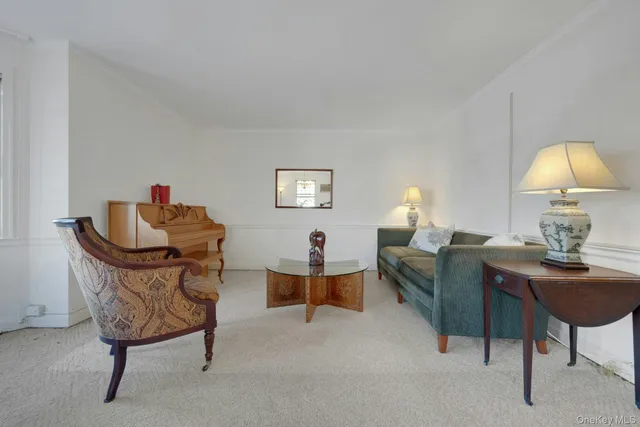 a living room with furniture and a lamp
