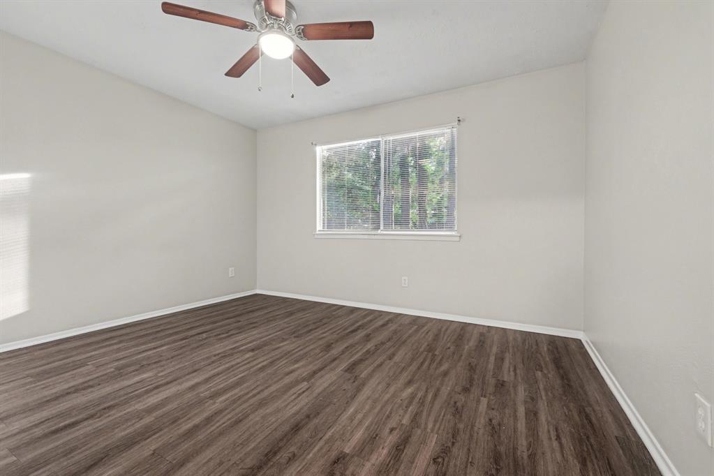 1321 North 7th Street Conroe, TX 77301 - Photo 14 of 17 wooden floor in an empty room with a window