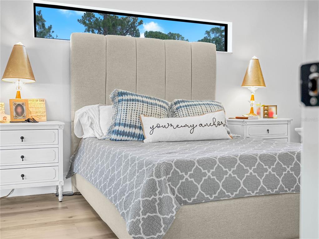 1850 South Lake Reedy Boulevard Frostproof, FL 33843 - Photo 15 of 36 a bedroom with a bed and a lamp on dresser