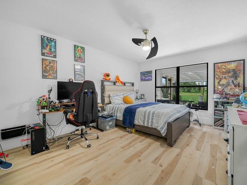 1850 South Lake Reedy Boulevard Frostproof, FL 33843 - Photo 23 of 36 a bedroom with a bed a large window and book self