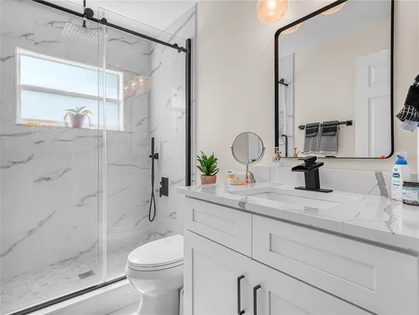a bathroom with a sink toilet and shower