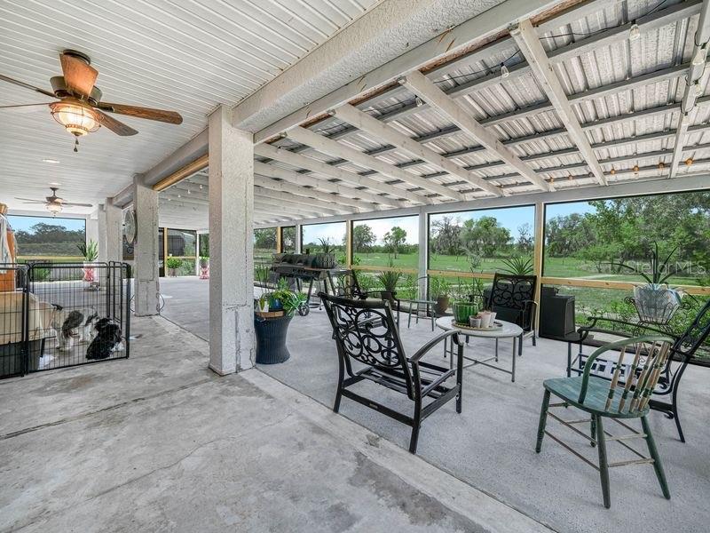 1850 South Lake Reedy Boulevard Frostproof, FL 33843 - Photo 31 of 36 a view of a patio with table and chairs potted plants with floor to ceiling window
