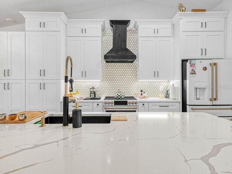 1850 South Lake Reedy Boulevard Frostproof, FL 33843 - Photo 8 of 36 a kitchen with stainless steel appliances a refrigerator sink and cabinets