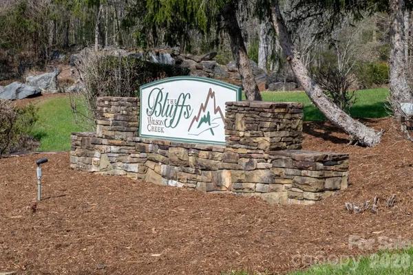 a view of building with wooden fence