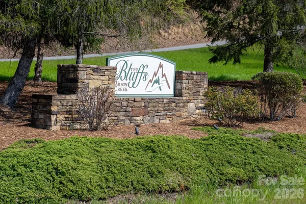 a view of a sign board with a yard