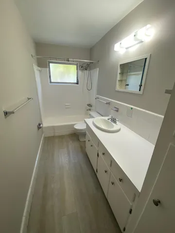 a bathroom with a sink a mirror and a bathtub