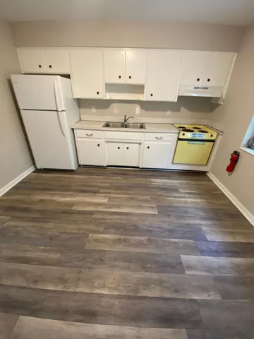 a view of kitchen with wooden floor