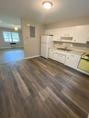 a view of a kitchen with stove and cabinets