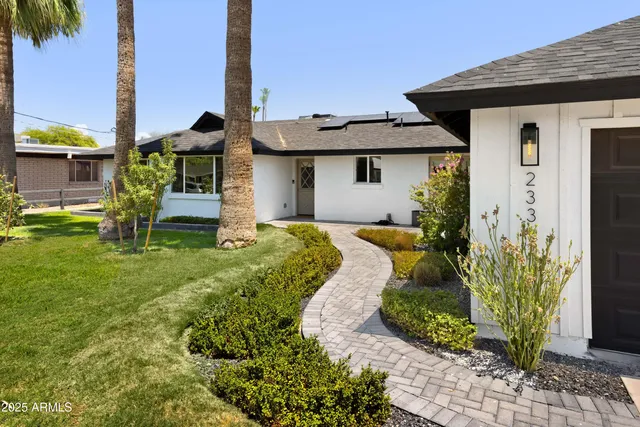 a front view of a house with garden