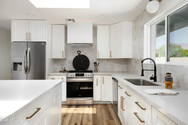a kitchen with a sink a stove and refrigerator