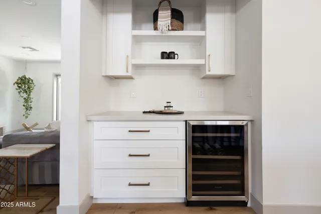 a kitchen with white cabinets and appliances