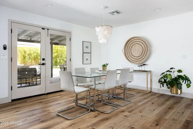a living room with furniture a window and wooden floor