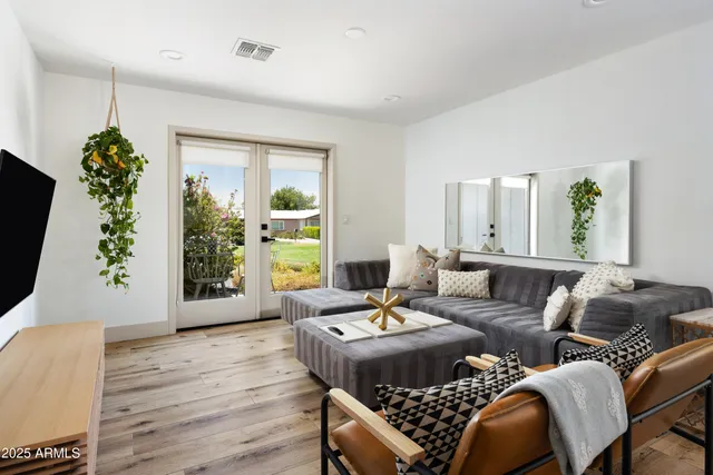 a living room with furniture and a large window